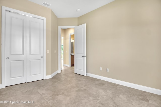 4335 Negal Cir, Melbourne, FL 32901 - unfurnished bedroom featuring baseboards and a closet