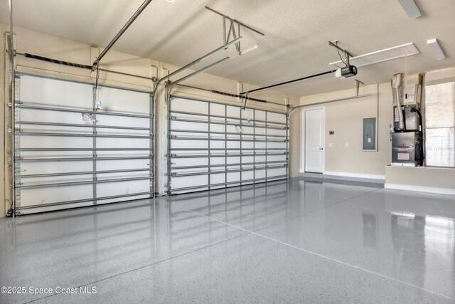 4335 Negal Cir, Melbourne, FL 32901 - garage with electric panel, a garage door opener, and baseboards