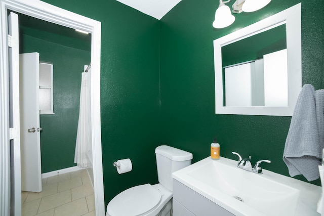 bathroom with toilet, tile floors, and vanity