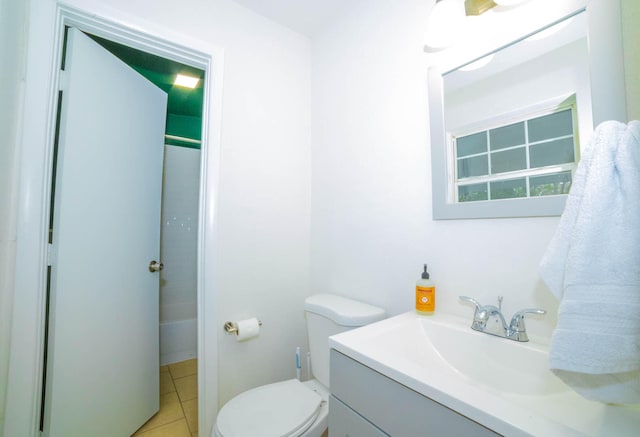 bathroom with toilet, large vanity, and tile floors