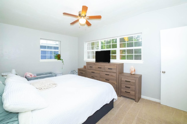 bedroom featuring light carpet and ceiling fan