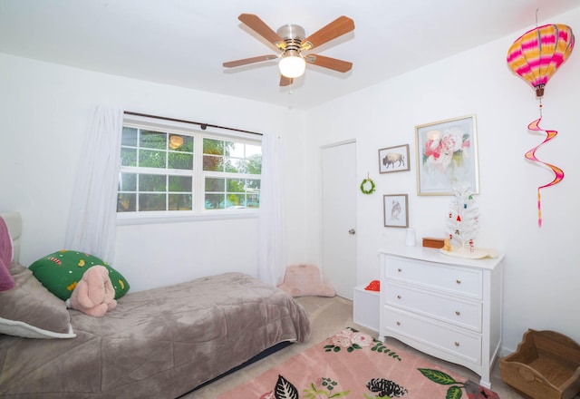 bedroom featuring light colored carpet and ceiling fan