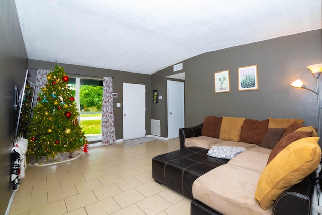 tiled living room featuring vaulted ceiling