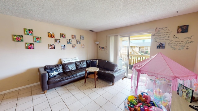 game room featuring a textured ceiling and light tile flooring