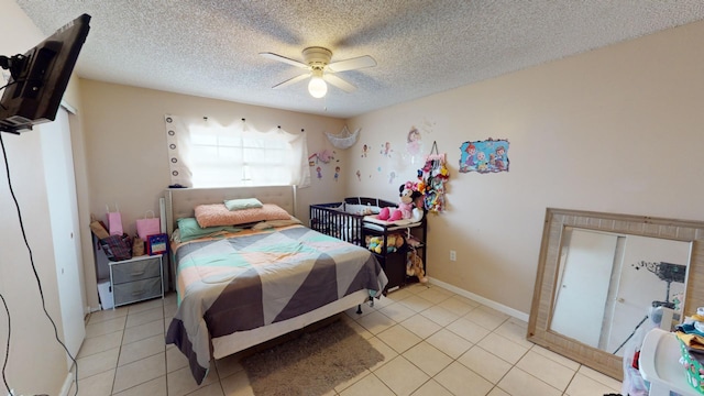 tiled bedroom with a textured ceiling and ceiling fan