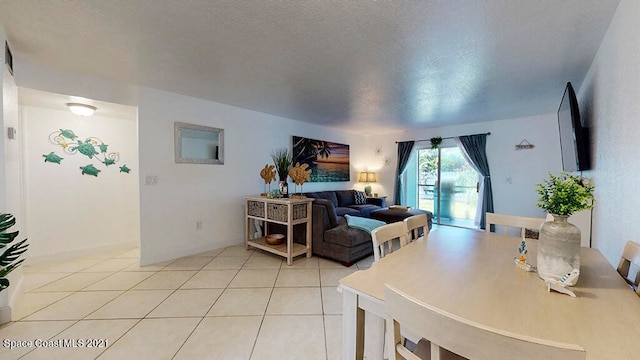 living room featuring a textured ceiling and light tile floors