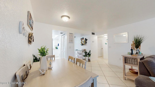 dining space with light tile floors