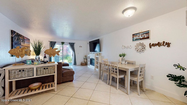 tiled dining room with a textured ceiling