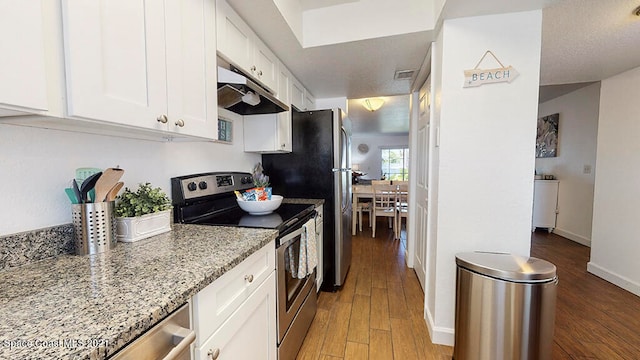 kitchen with light stone counters, wood-type flooring, white cabinetry, and stainless steel electric range