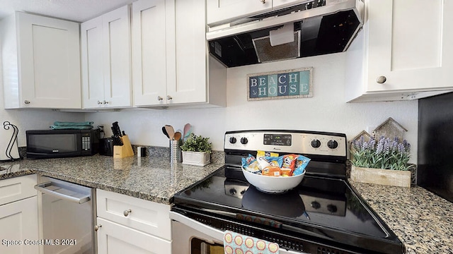 kitchen with stainless steel appliances, light stone counters, and white cabinetry