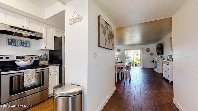 kitchen featuring stainless steel appliances, hardwood / wood-style floors, and white cabinets