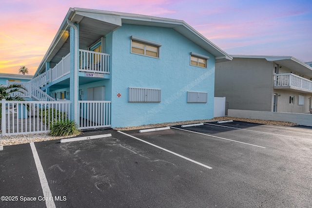 180 Flagler Ln Unit 22, Cocoa Beach, FL 32931 - parking at dusk featuring uncovered parking