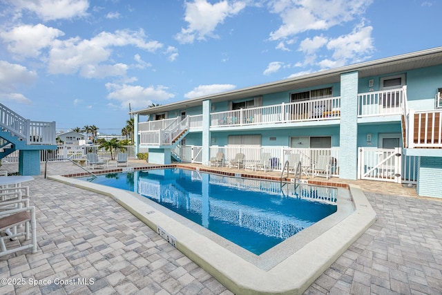 180 Flagler Ln Unit 22, Cocoa Beach, FL 32931 - community pool featuring stairs and a patio