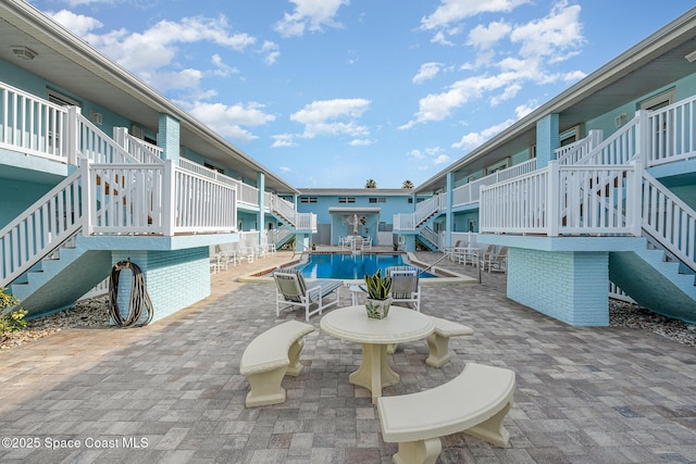 180 Flagler Ln Unit 22, Cocoa Beach, FL 32931 - community pool featuring stairs and a patio