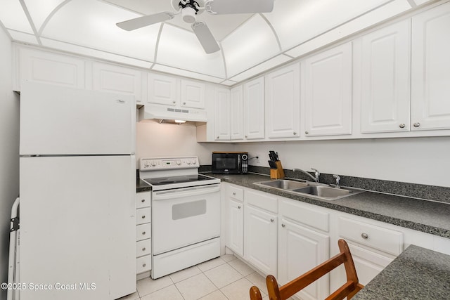 180 Flagler Ln Unit 22, Cocoa Beach, FL 32931 - kitchen featuring white appliances, under cabinet range hood, a sink, and dark countertops