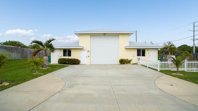 view of front of property featuring a garage and a front lawn