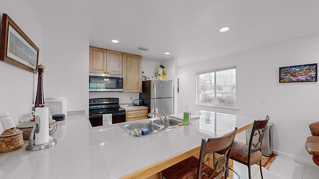 kitchen featuring light brown cabinetry, light tile flooring, kitchen peninsula, stainless steel appliances, and sink