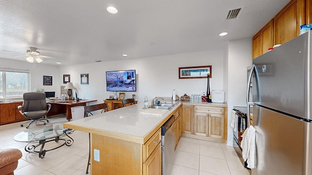 kitchen with a textured ceiling, stainless steel appliances, sink, ceiling fan, and light tile floors