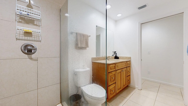 bathroom with tile flooring, vanity, and toilet