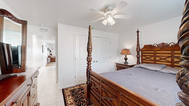 tiled bedroom featuring a closet and ceiling fan