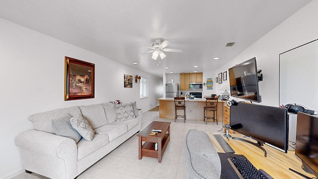 tiled living room with ceiling fan