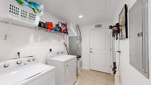 laundry area with electric dryer hookup, independent washer and dryer, and light tile floors