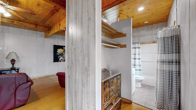 full bathroom featuring shower / bathtub combination with curtain, tile flooring, wood ceiling, ceiling fan, and toilet