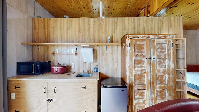 kitchen with fridge and wood ceiling