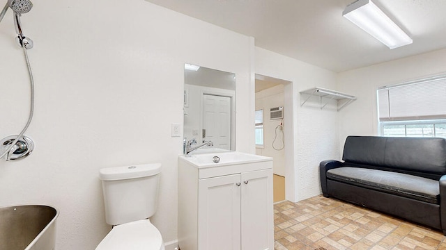 bathroom with oversized vanity, toilet, and tile floors