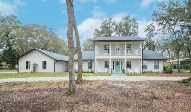 view of front of property featuring a balcony and a porch