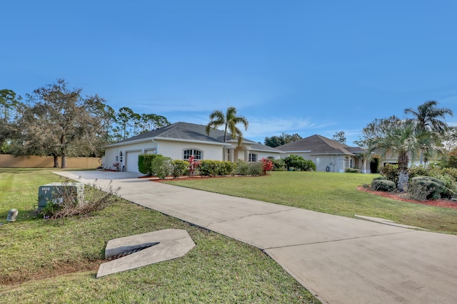 single story home featuring a front lawn and a garage