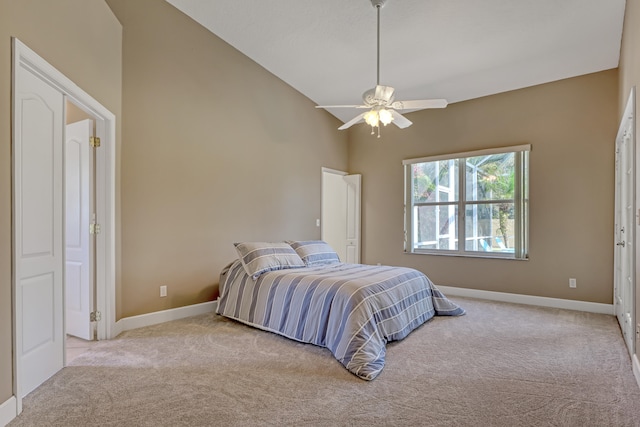 carpeted bedroom with high vaulted ceiling and ceiling fan