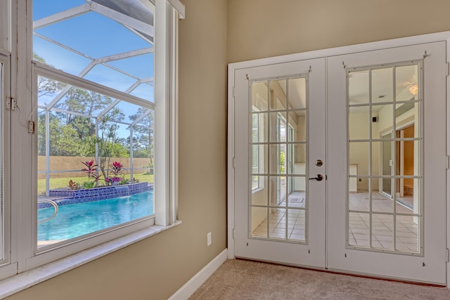 doorway featuring light colored carpet and french doors