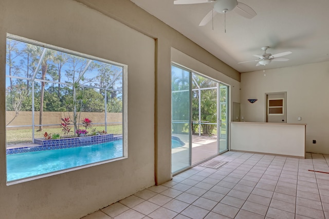 doorway to outside with light tile floors and ceiling fan