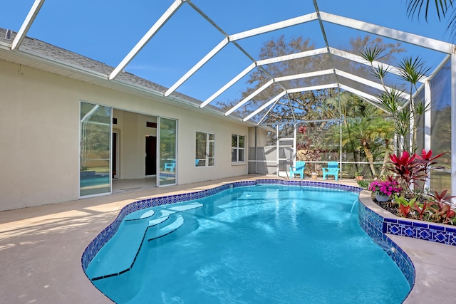 view of swimming pool with a patio area, a lanai, and pool water feature