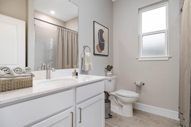 bathroom featuring vanity, toilet, and curtained shower