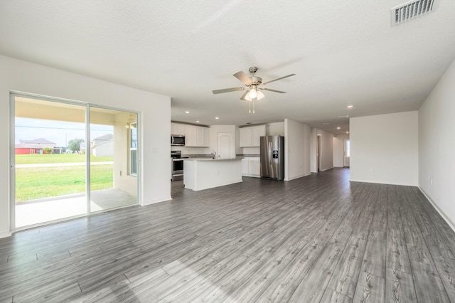 unfurnished living room featuring a textured ceiling, ceiling fan, and light hardwood / wood-style flooring