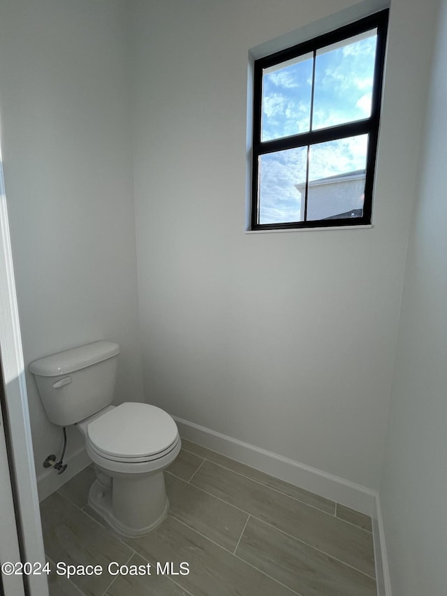 8526 Lyside Dr, Melbourne, FL 32940 - bathroom with toilet and baseboards