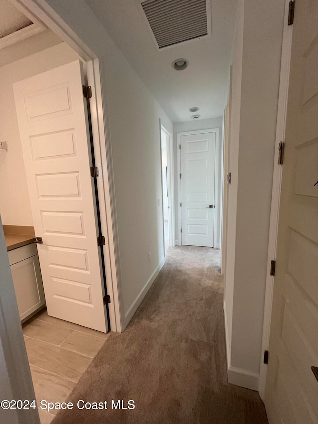 corridor with light colored carpet