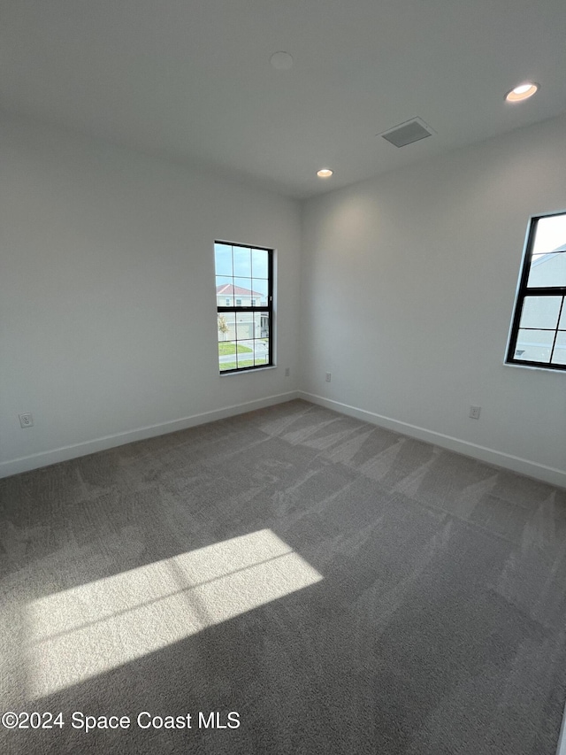 8526 Lyside Dr, Melbourne, FL 32940 - unfurnished room featuring baseboards, recessed lighting, and carpet flooring