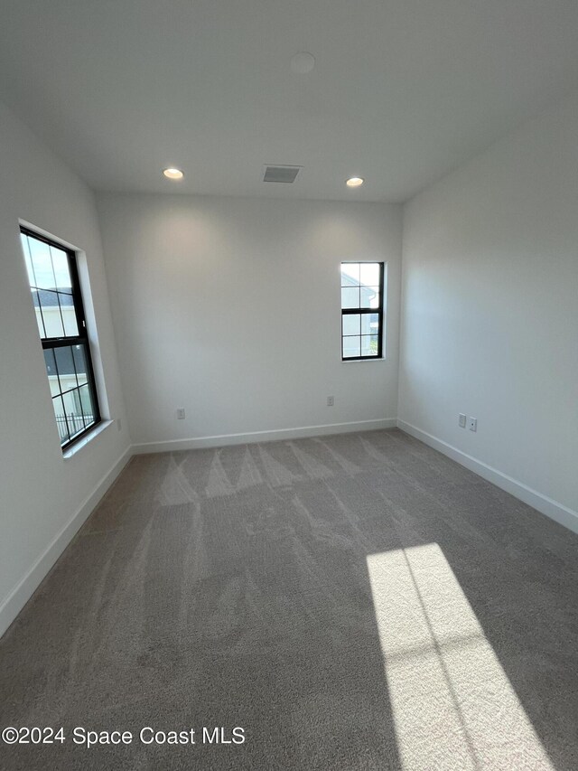 8526 Lyside Dr, Melbourne, FL 32940 - carpeted empty room with visible vents, recessed lighting, and baseboards