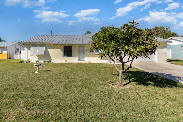 view of front of property with a front lawn and a garage