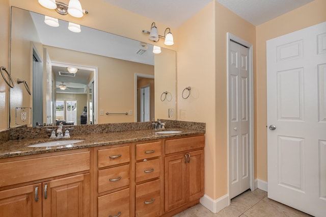 bathroom with tile floors, ceiling fan, and dual bowl vanity