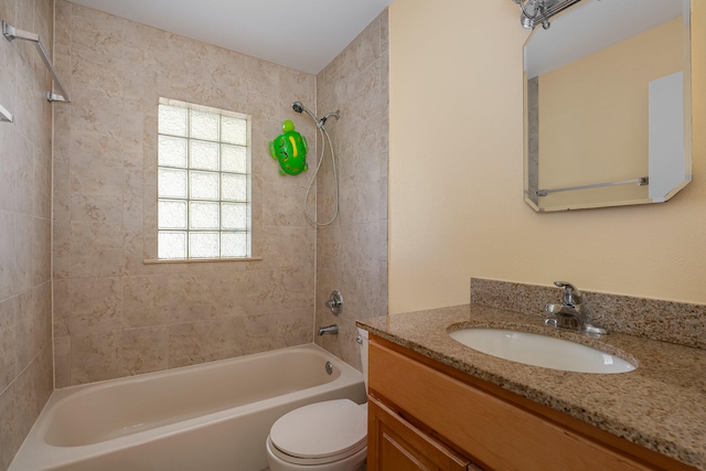 full bathroom featuring plenty of natural light, large vanity, tiled shower / bath combo, and toilet