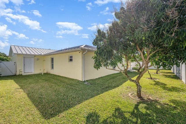 rear view of house with a yard