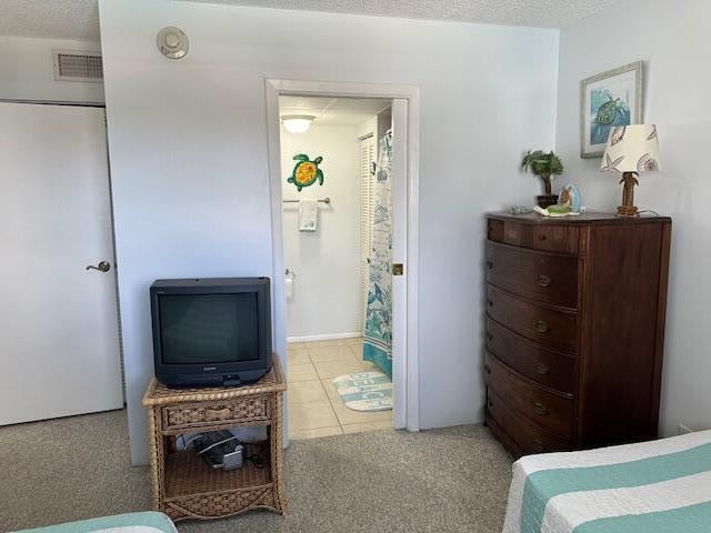 bedroom with a textured ceiling and carpet