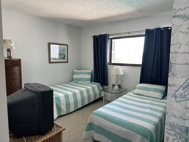 carpeted bedroom with a textured ceiling