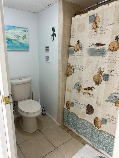 bathroom featuring tile floors and toilet