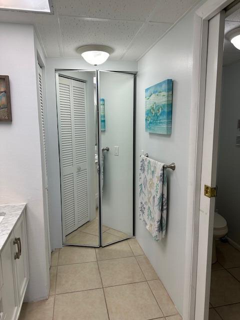 bathroom with tile floors, toilet, and vanity