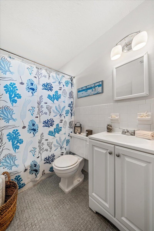 bathroom featuring tile walls, toilet, backsplash, tile flooring, and vanity